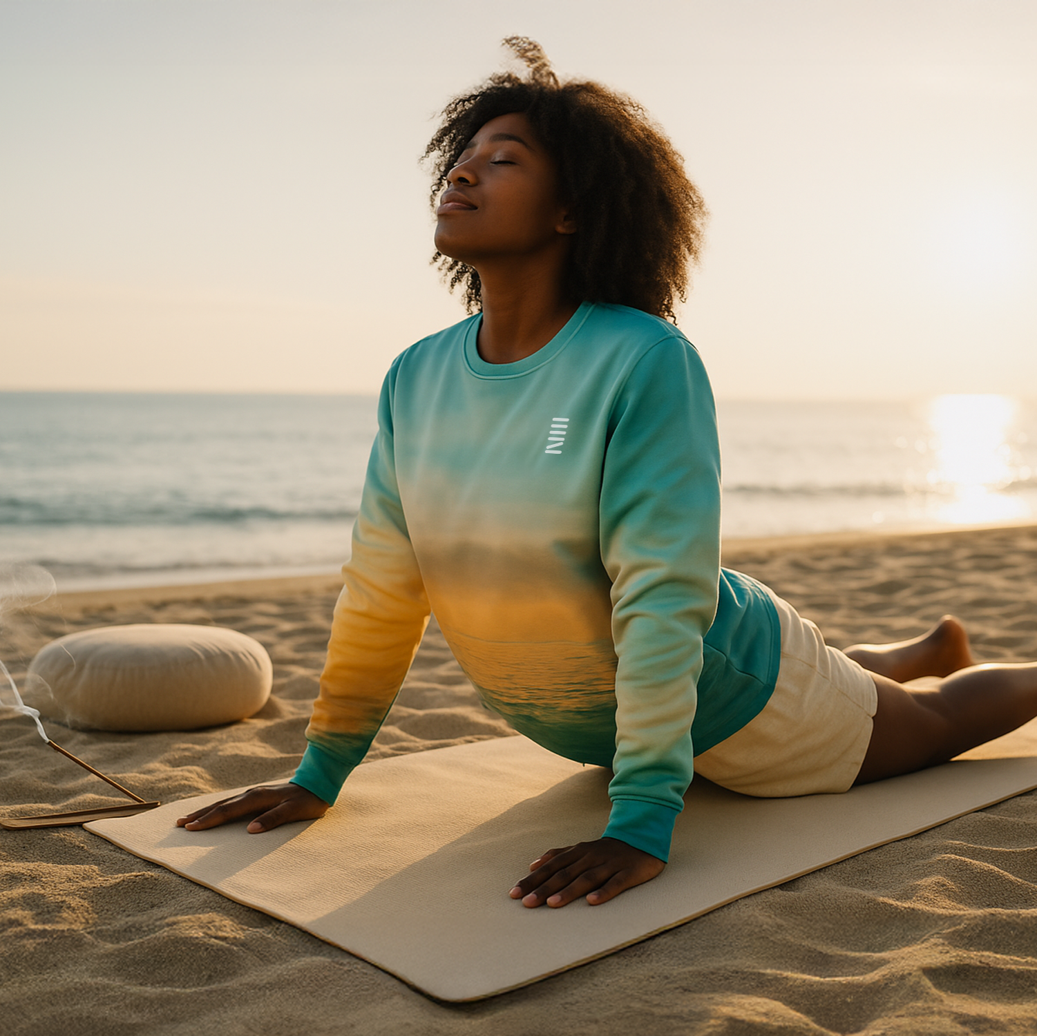 Person practicing yoga on a beach at sunset with a draped curtain.