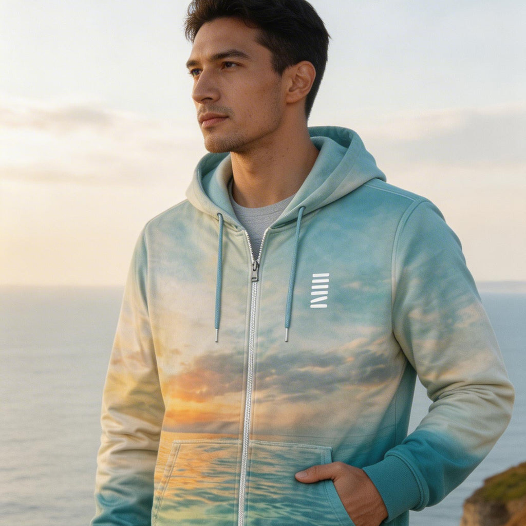 Man wearing a hoodie with a scenic design by the ocean